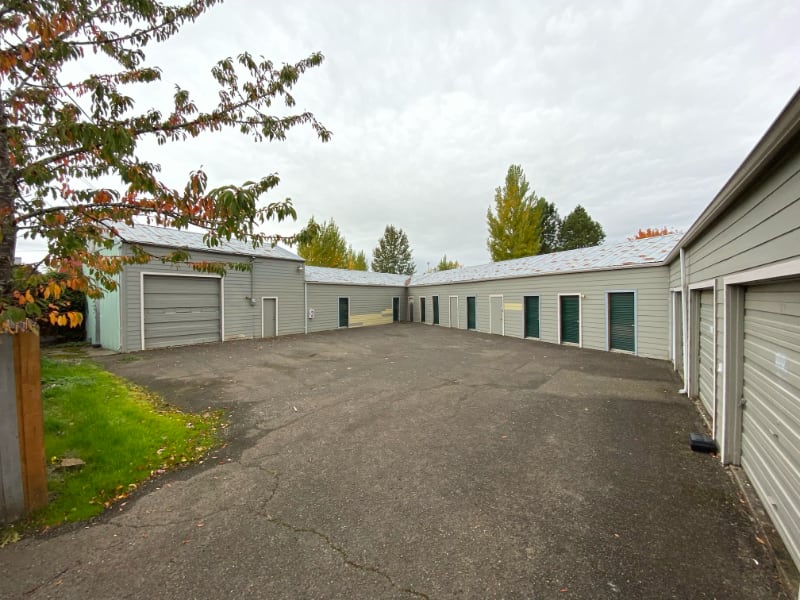 Drive-up self-storage units at 485 Harrison St in Lebanon, OR with spacious asphalt lot and metal roll-up doors